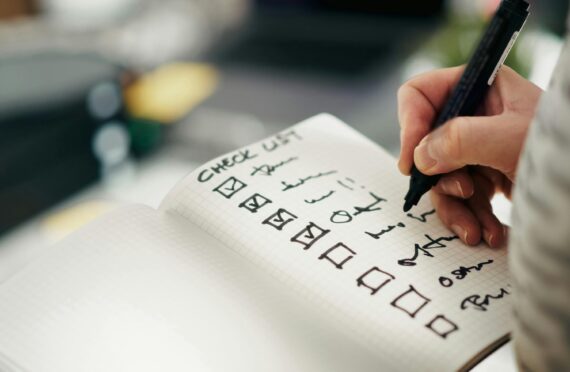Hand writing checklist in notebook