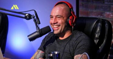 Man smiling with headphones and microphone